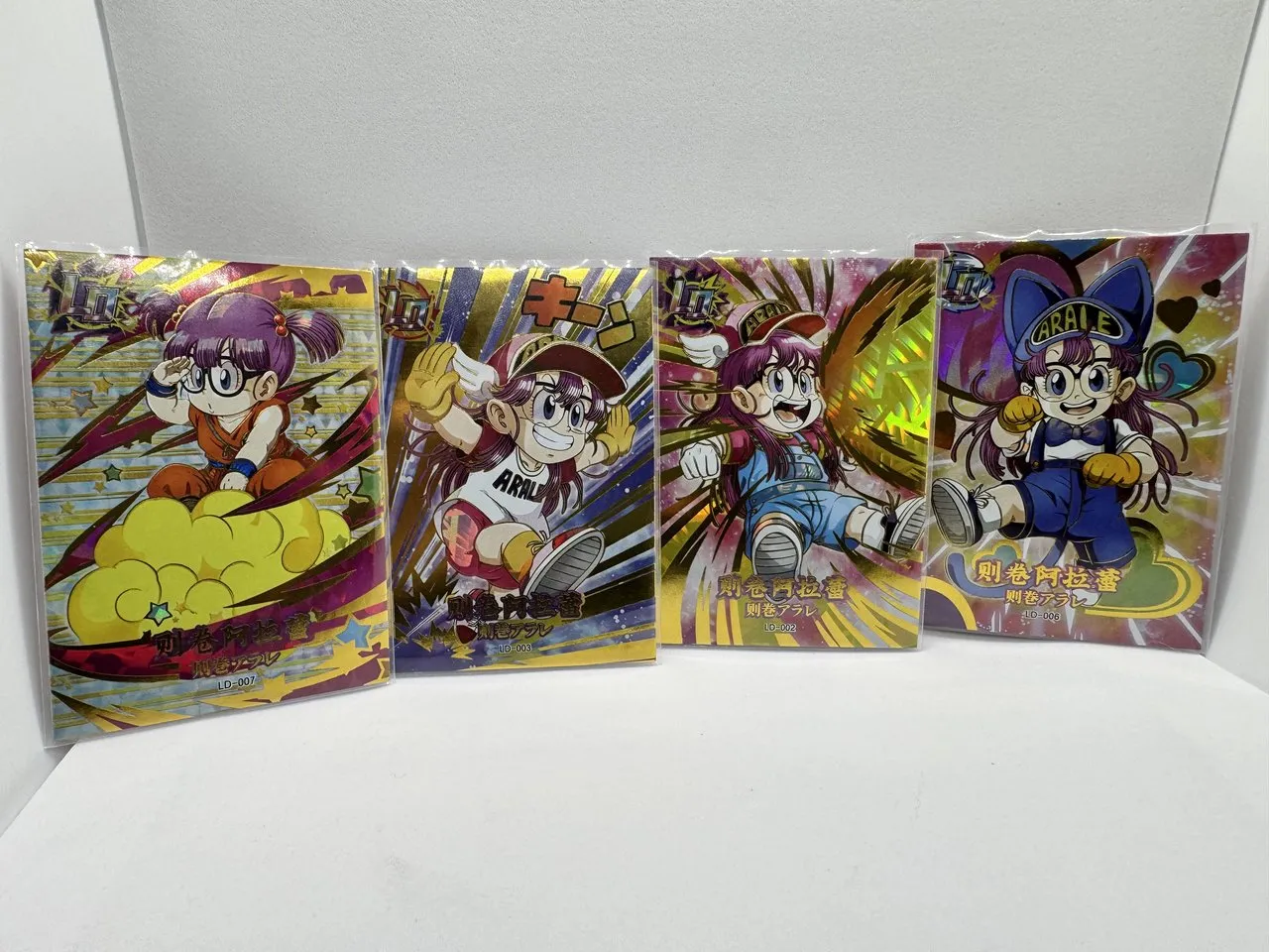 A lot of four foil Arale Norimaki cards (LD-002, LD-003, LD-006, LD-007) from a doujin Akira Toriyama tribute set