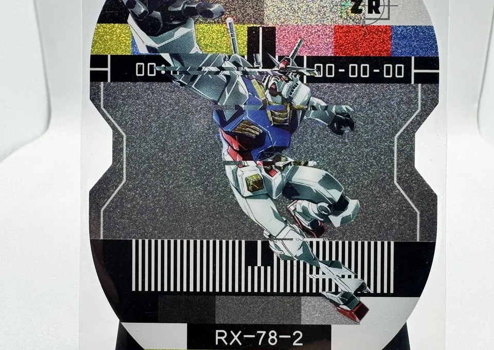 A die-cut foil RX-78-2 Gundam card from LeCard's Gundam Sentinel fan-art set, standing on a display easel