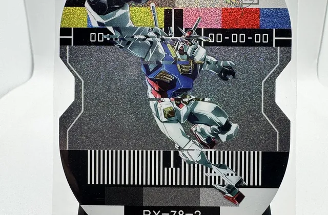 A die-cut foil RX-78-2 Gundam card from LeCard's Gundam Sentinel fan-art set, standing on a display easel