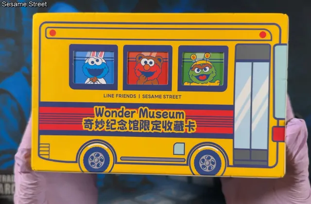 The Vancards Wonder Museum box, a yellow school bus with Cookie Monster, Elmo, and Oscar the Grouch in the windows